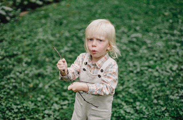 toddler chewing on shirt